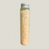 Glass bottle filled with a light-colored salt, magnesium, and shredded soap on a gray background